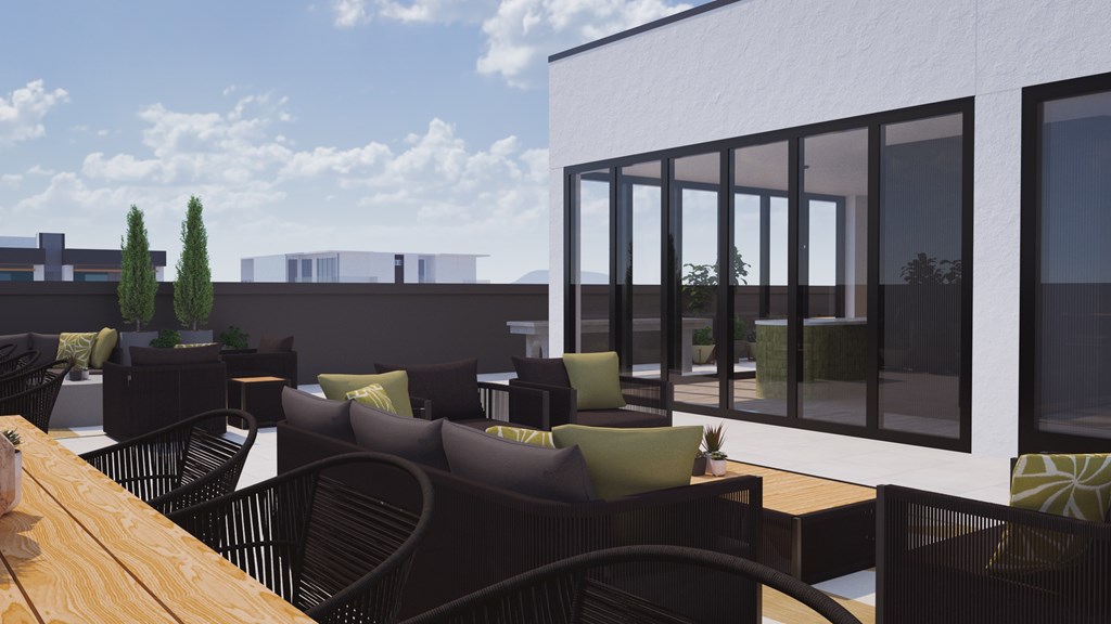 A patio with black chairs and a table.