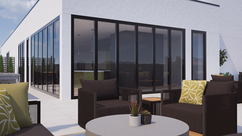 A modern patio with a white table and brown chairs.