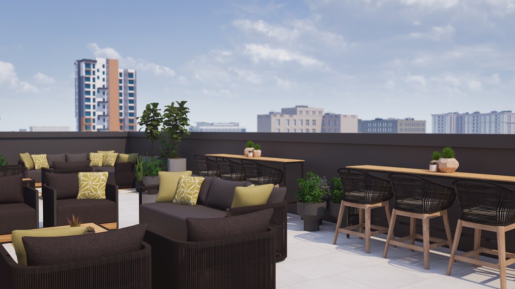 A patio with brown chairs and tables with green cushions.