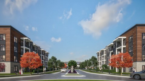 A street view of a residential area with modern apartment buildings and trees.