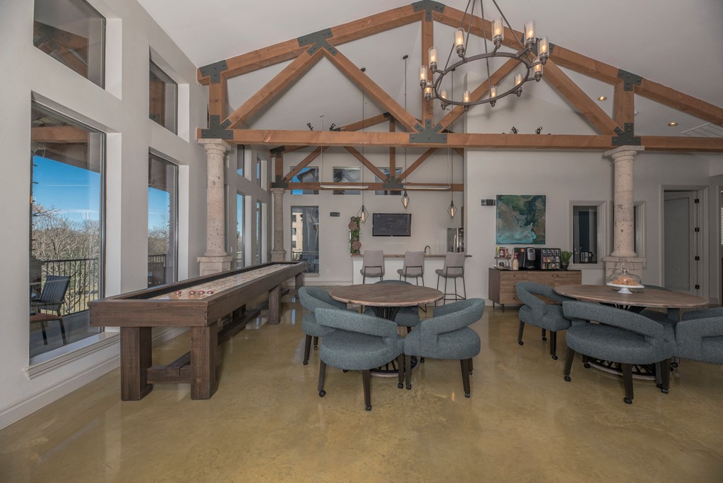 a dining room with tables and chairs and a pool table