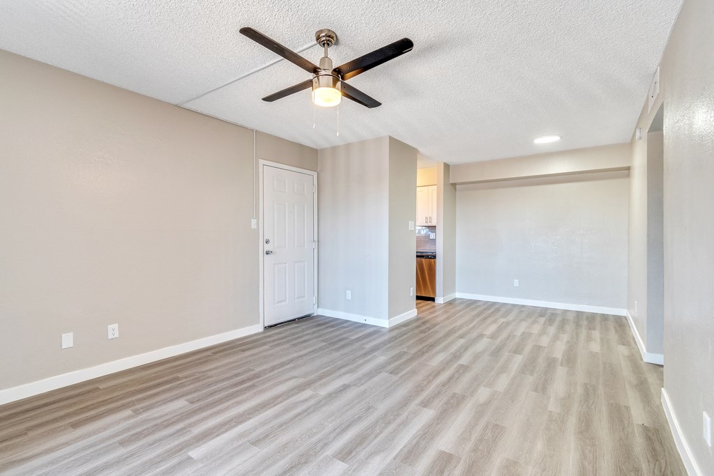 a living room with hardwood floors and a ceiling fan