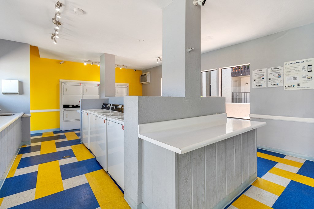 a kitchen with a yellow and gray floor