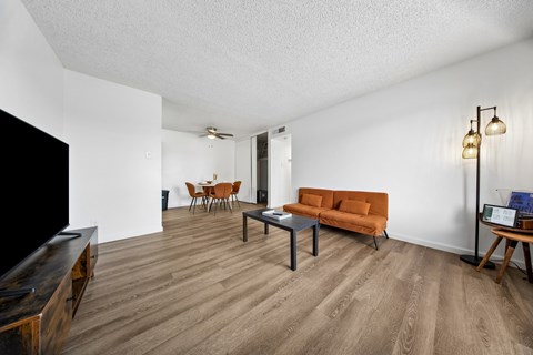 A living room with a brown couch and a wooden coffee table.