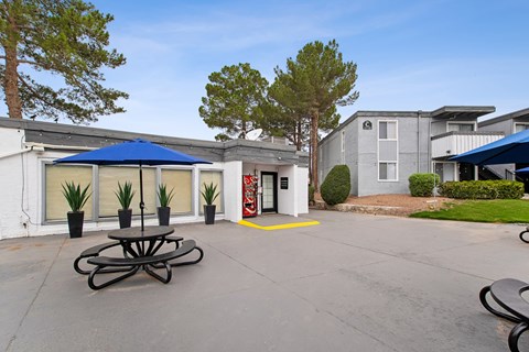 A large white building with a blue canopy and a red fire hydrant in front.