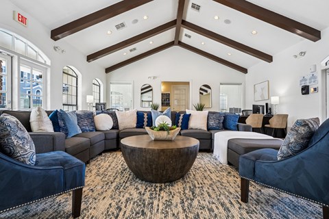 A large, modern living room with a variety of seating options and a coffee table.
