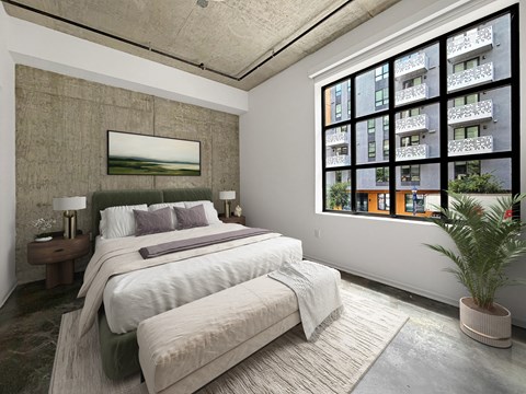 A bedroom with two beds and a large window.
