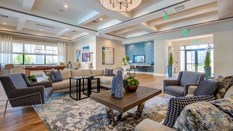 a living room with couches and chairs and a table