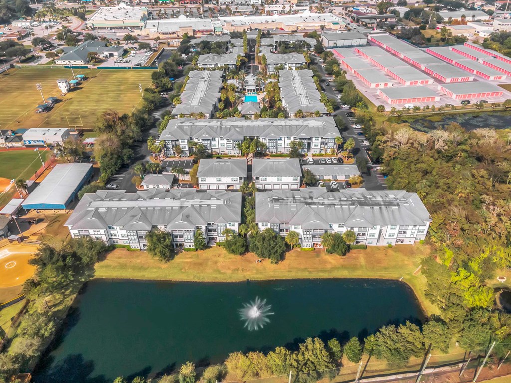 an aerial view of a city with buildings and a lake