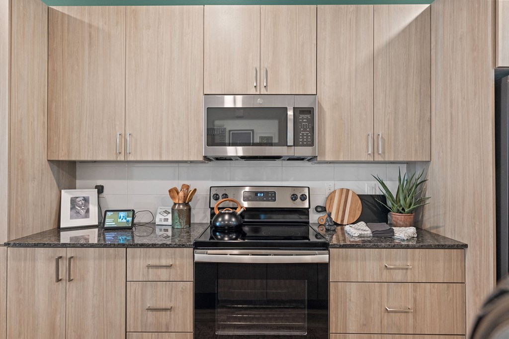 a kitchen with wooden cabinets and a stove and a microwave