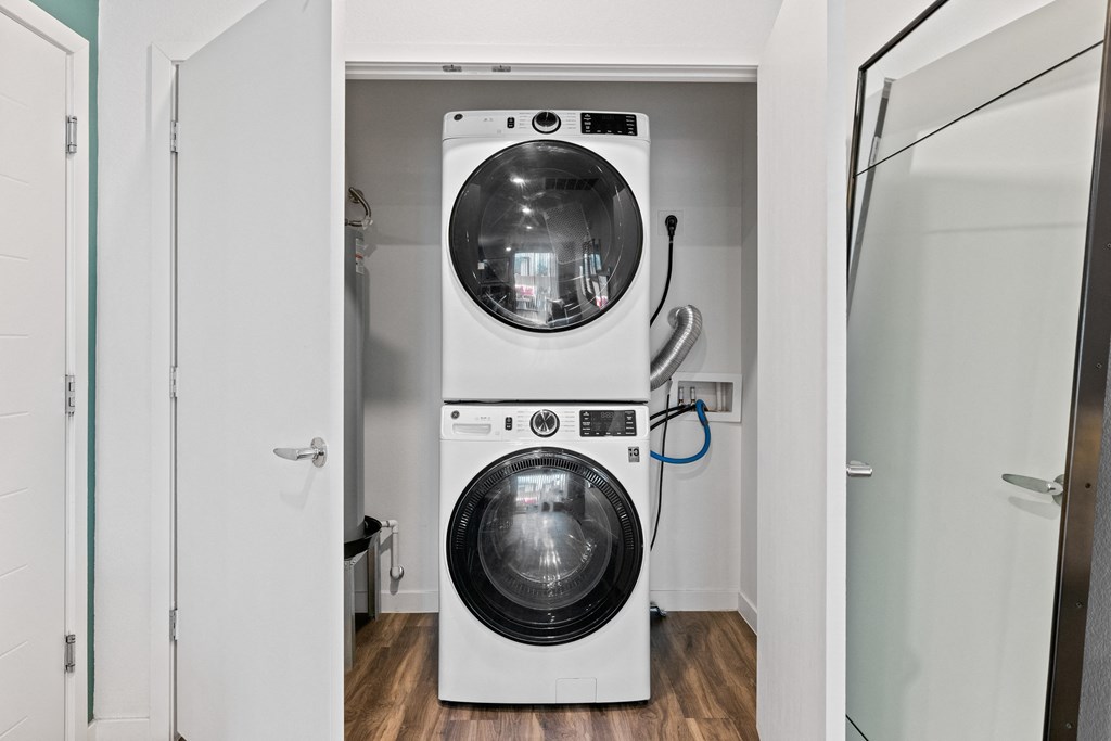 a white washer and dryer in a white laundry room