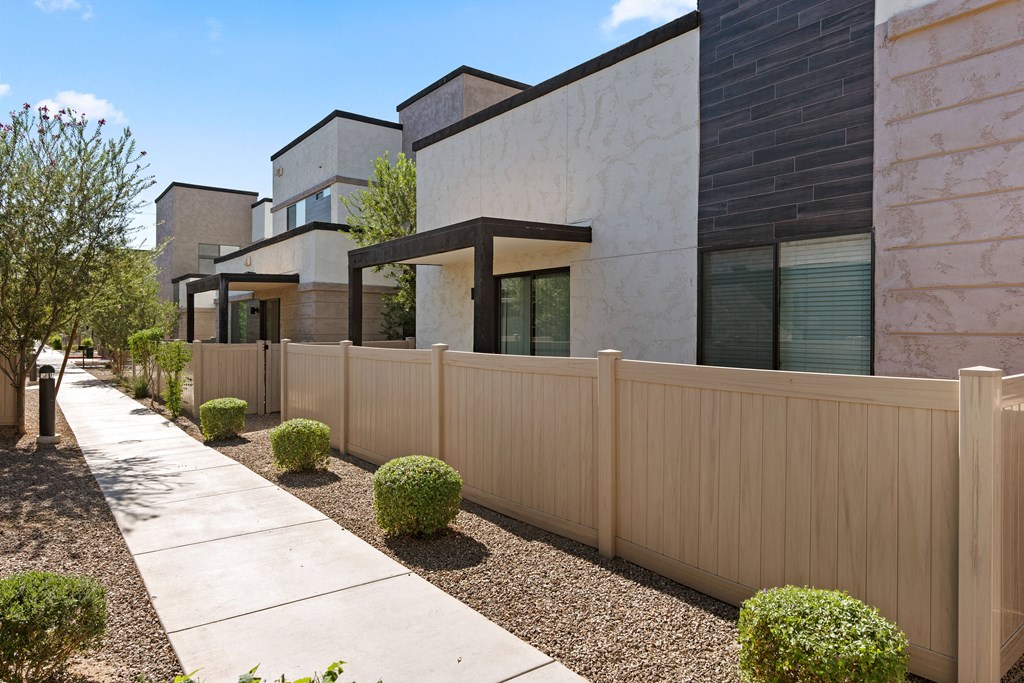 a wooden fence in front of a row of houses