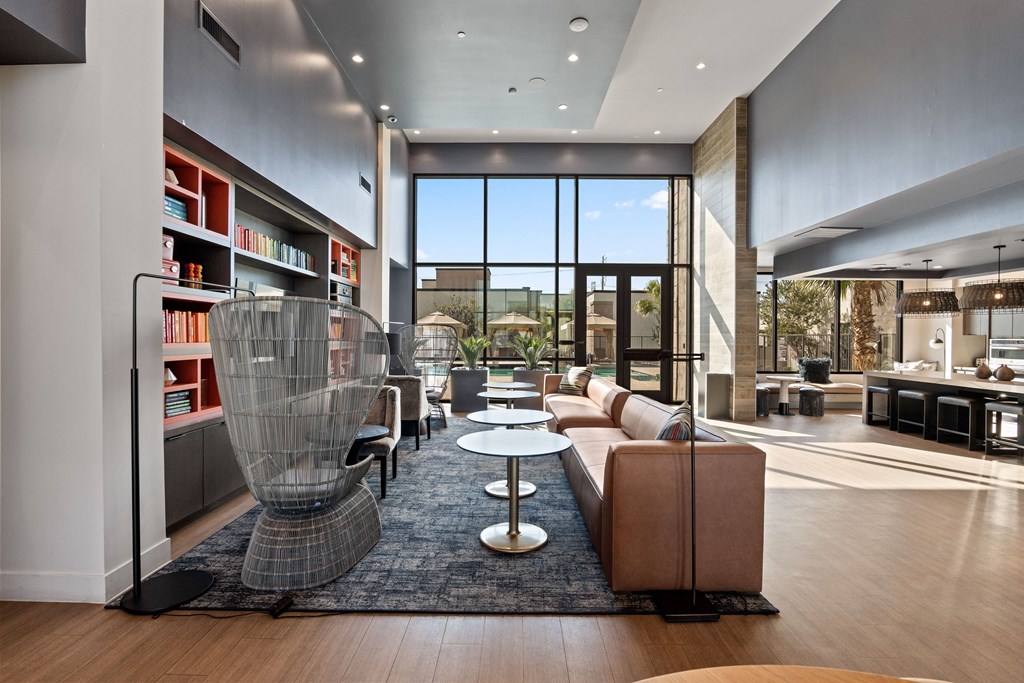 a living room filled with furniture and a large window