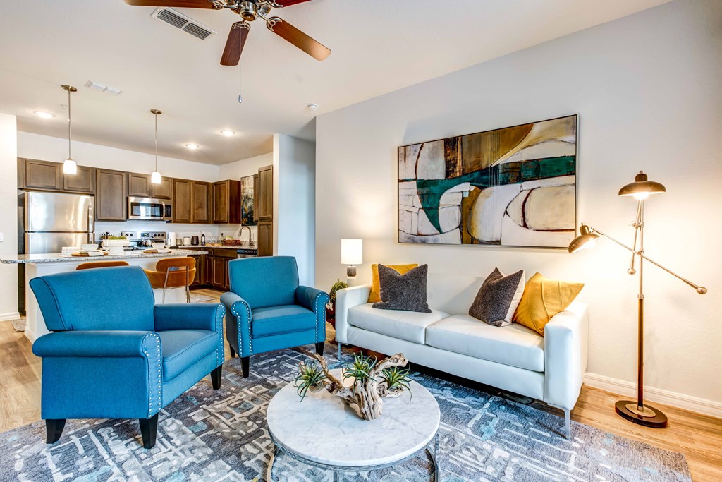 a living room with blue chairs and a white couch