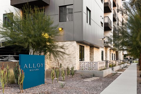 A sign that says Alloy Midtown is in front of a building.