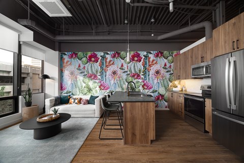 A modern kitchen with a wooden island and a large floral mural on the wall.