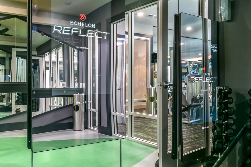 A glass wall with the word REFLECT on it.