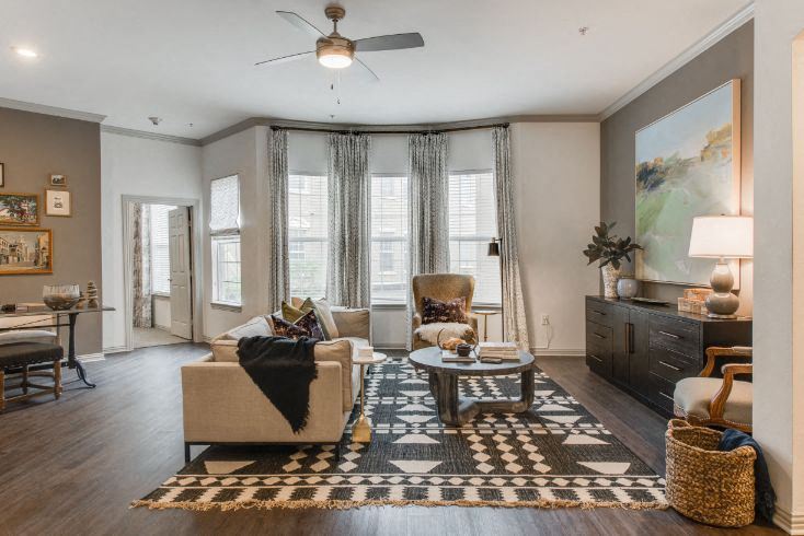 a living room with furniture and a ceiling fan
