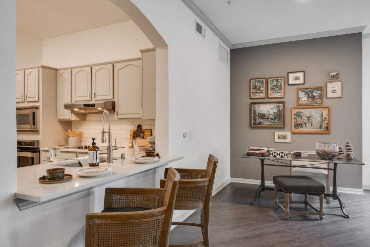 a kitchen and dining room with a table and chairs