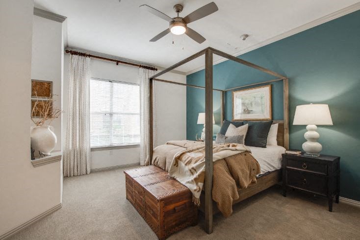 a bedroom with a bed and a ceiling fan