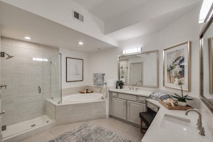 a bathroom with a tub and a sink and a shower