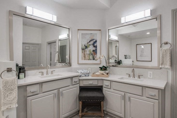 a bathroom with two sinks and a large mirror