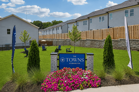 A sign that says "The Towns" is in front of a building.