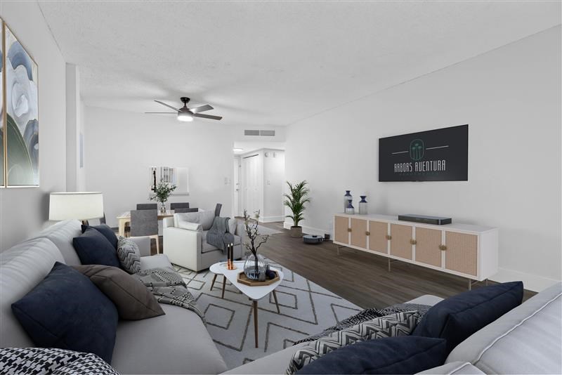 A living room with a white couch and a coffee table.