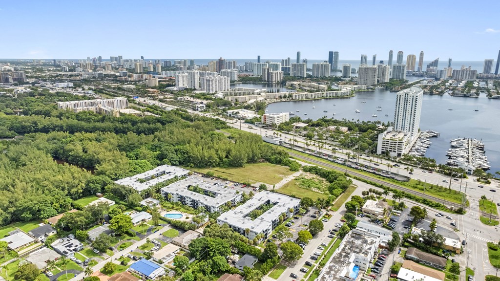 A bird's eye view of a city with a large body of water in the foreground.