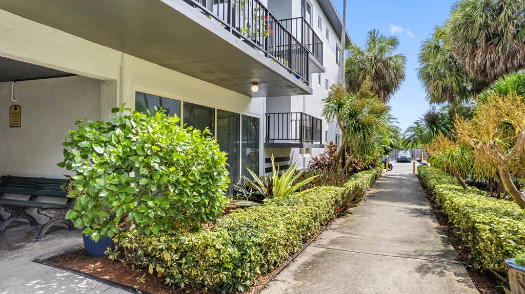 A sunny day at a residential building with a well-maintained garden.