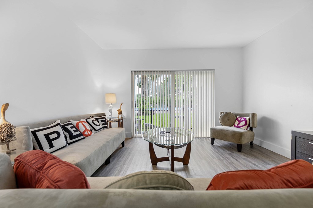 A living room with a grey couch and a chair.