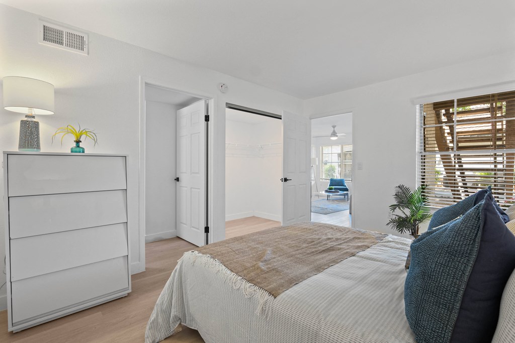 a bedroom with a bed and a closet