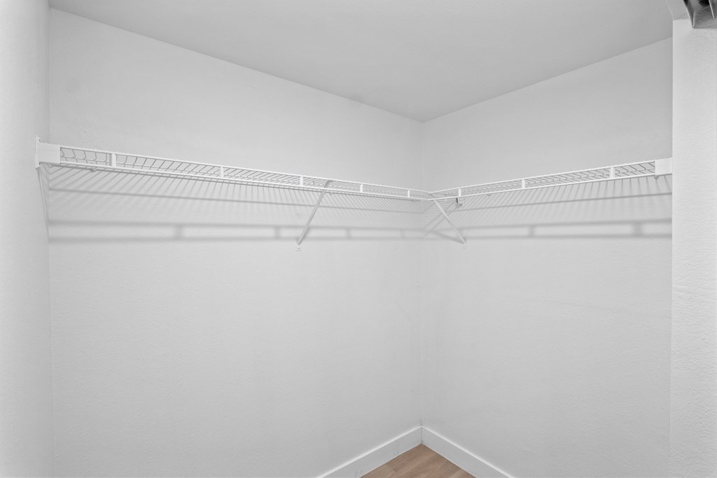 the spacious closet in the living room of an apartment with white walls