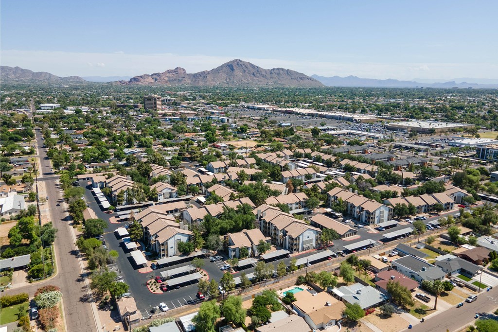 an aerial view of a city with a mountain in the background