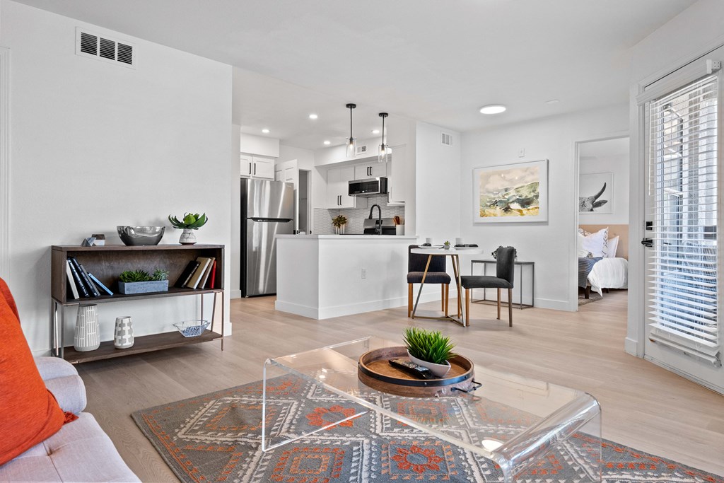 an open living room and kitchen with a table and chairs
