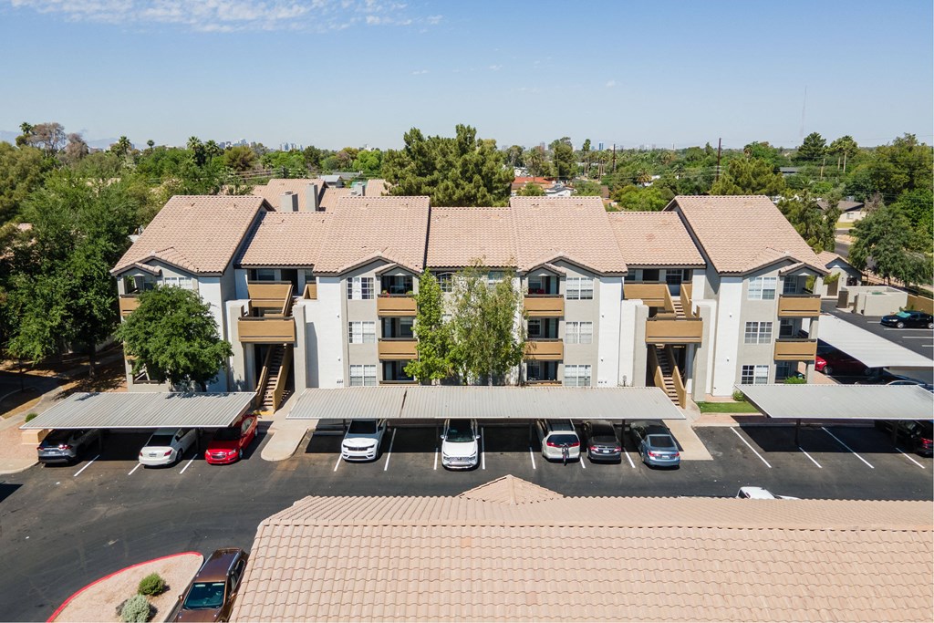 an aerial view of an apartment complex with a parking lot