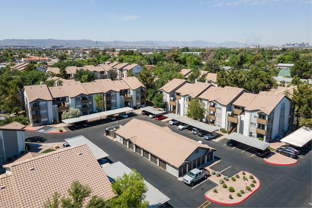 an aerial view of a group of houses in a parking lot