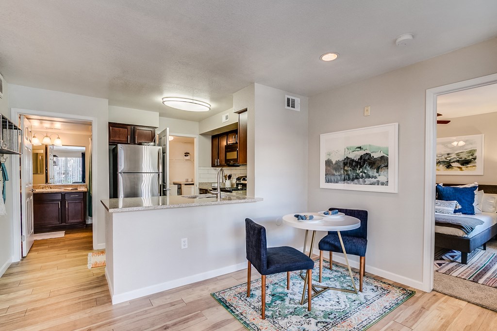 a dining area with two chairs and a small table