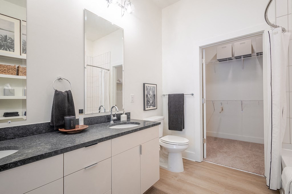 A bathroom with a sink, toilet, and shower.