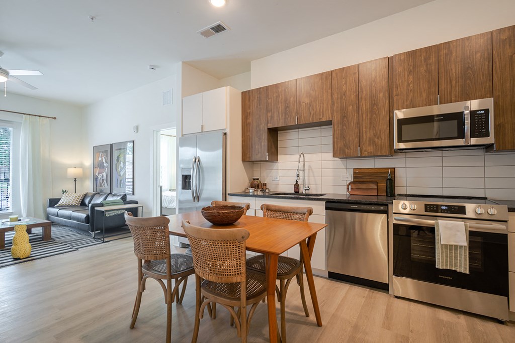 A modern kitchen with a dining table and chairs.