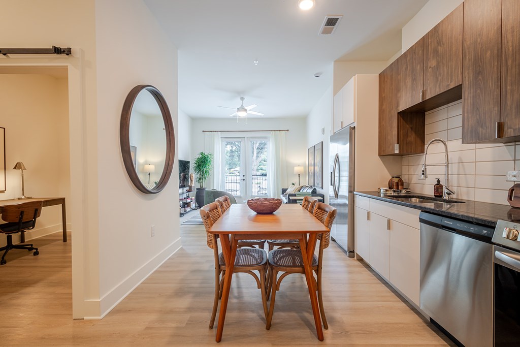 A modern kitchen with a dining table and chairs.