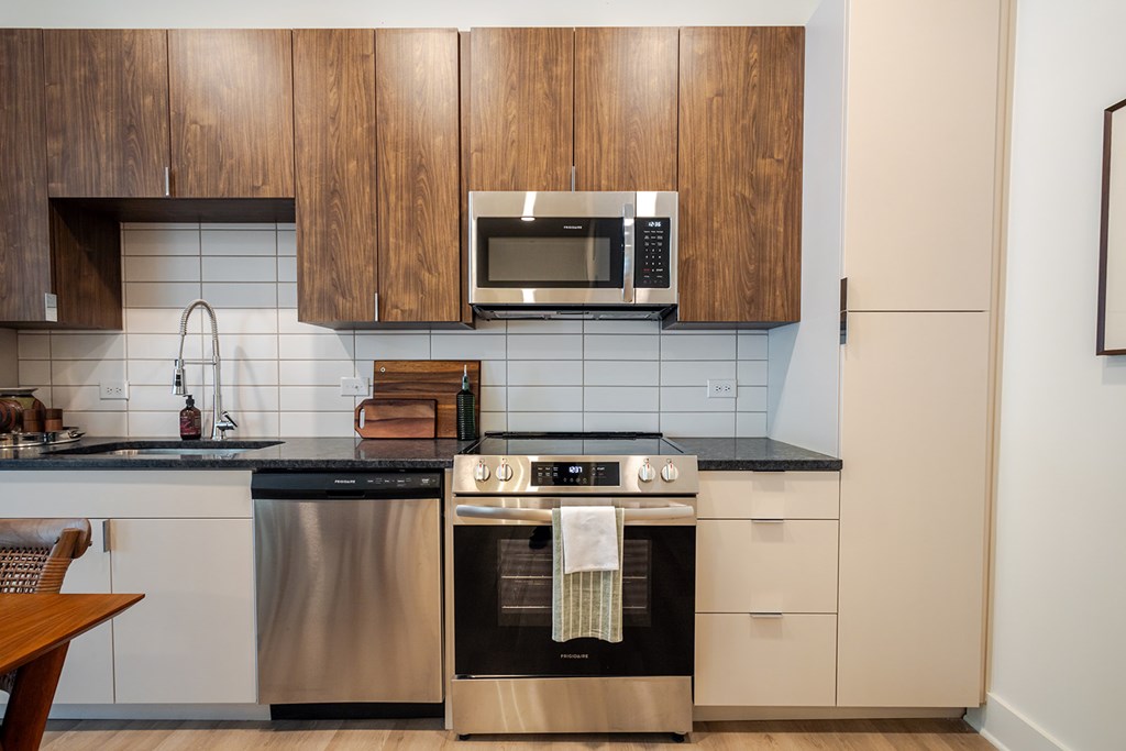 A modern kitchen with wooden cabinets and stainless steel appliances.