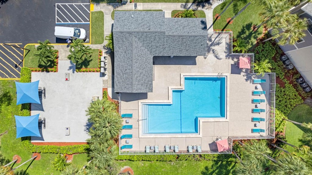 A large building with a pool in front of it.