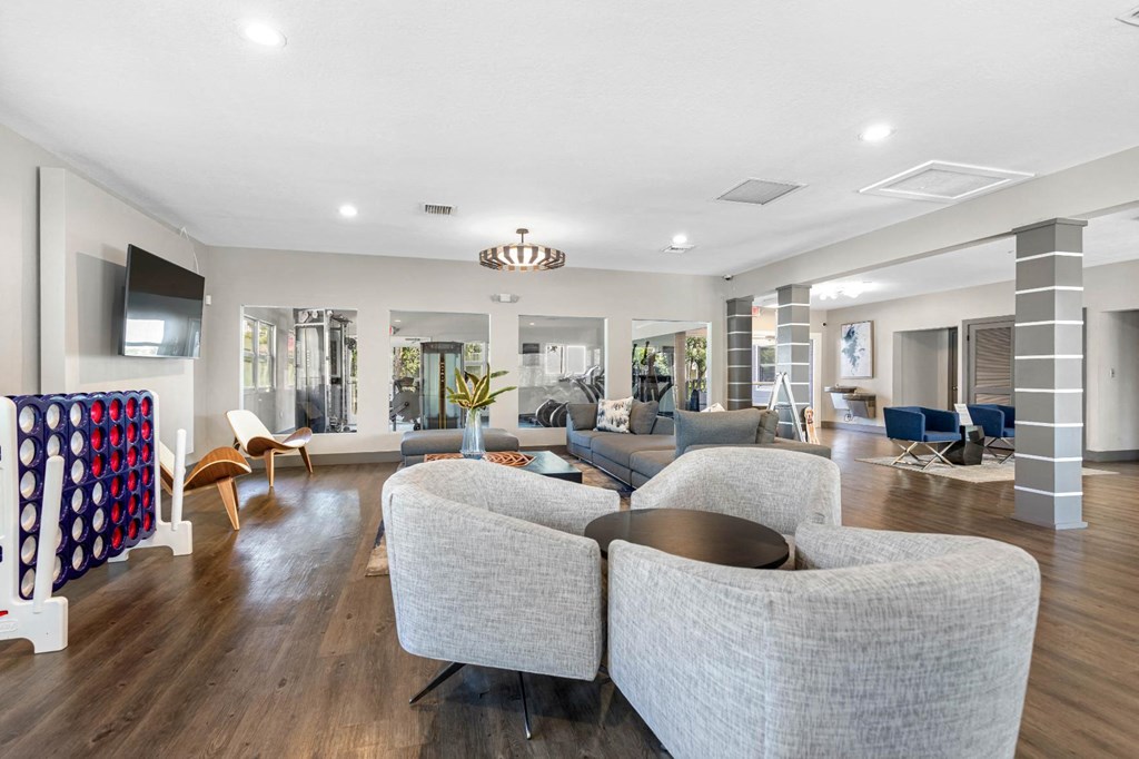 a living room with couches and chairs and a tv