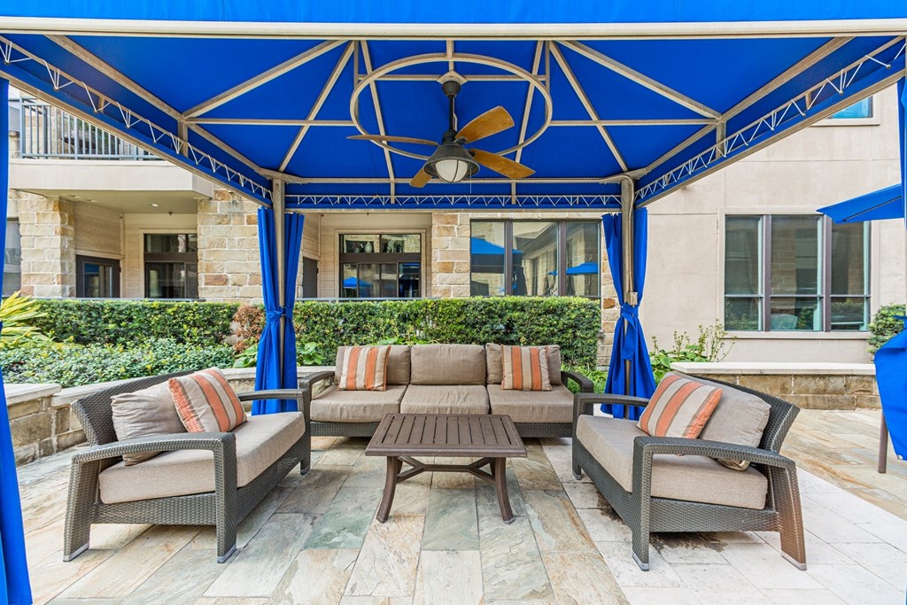 a patio with couches and chairs