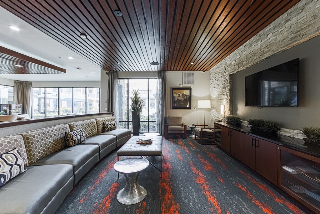 a large living room with couches and a television