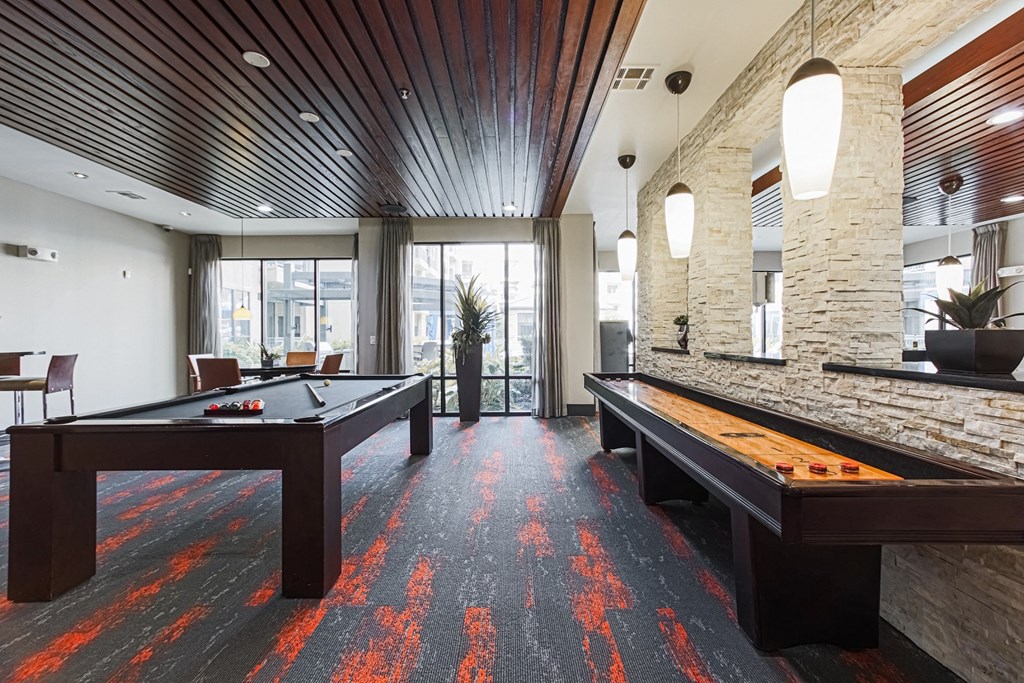 two pool tables in a game room at the district flats apartments