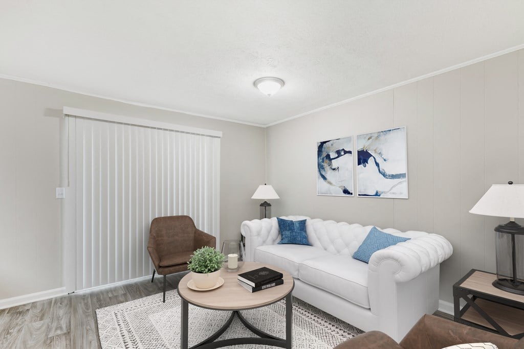 a living room with a white couch and a coffee table