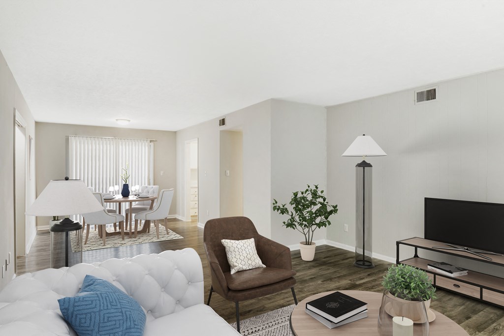 a living room with a white couch and a tv