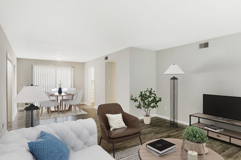 A living room with a brown chair and a white couch.